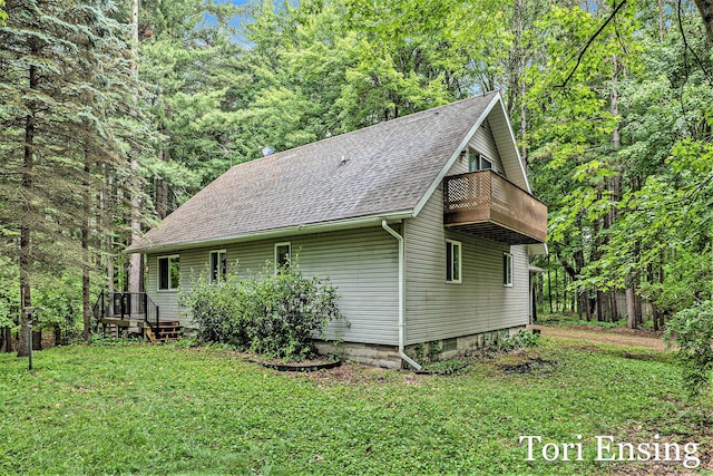 4366 Woods Rd, Sidney, MI 48885 - view of home's exterior featuring roof with shingles, a yard, a balcony, and a wooded view