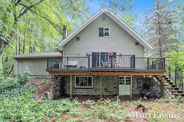 4366 Woods Rd, Sidney, MI 48885 - rear view of house with a wooden deck, stairs, and a chimney