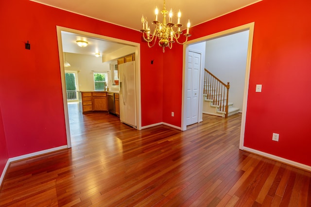 2683 Mystic Dr, Ann Arbor, MI 48103 - unfurnished dining area with a chandelier, dark wood-type flooring, and stairs
