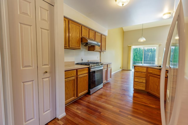 2683 Mystic Dr, Ann Arbor, MI 48103 - kitchen with stainless steel range with gas cooktop, under cabinet range hood, brown cabinetry, and hardwood / wood-style flooring