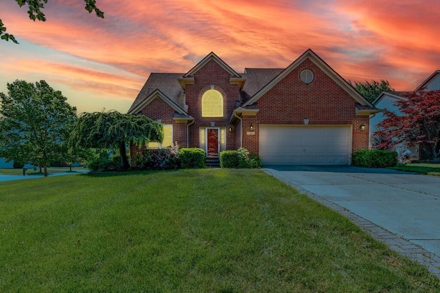 2683 Mystic Dr, Ann Arbor, MI 48103 - traditional home with brick siding, an attached garage, a yard, and concrete driveway