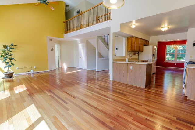 2683 Mystic Dr, Ann Arbor, MI 48103 - kitchen with white refrigerator with ice dispenser, light wood-type flooring, light countertops, and a high ceiling