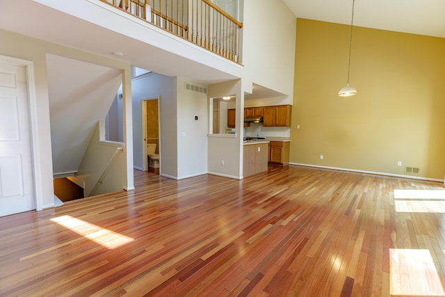2683 Mystic Dr, Ann Arbor, MI 48103 - unfurnished living room featuring light wood-style floors and a towering ceiling