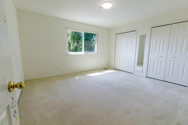 2683 Mystic Dr, Ann Arbor, MI 48103 - unfurnished bedroom with multiple closets and carpet