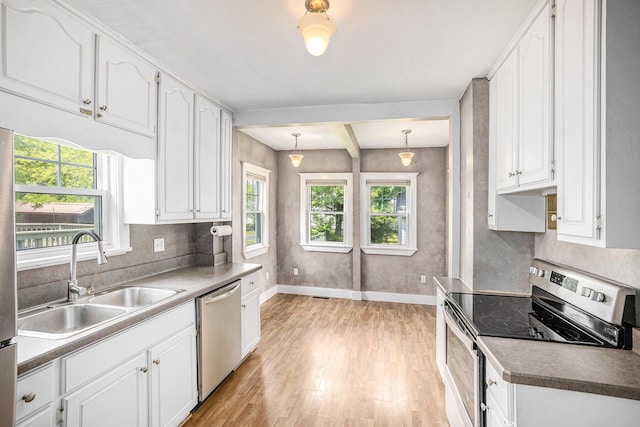 736 Glenwood Ave, Jackson, MI 49203 - kitchen with appliances with stainless steel finishes, light wood-style flooring, white cabinets, and beam ceiling