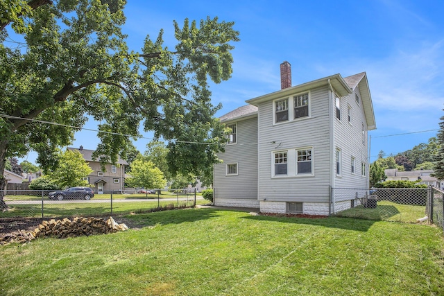 736 Glenwood Ave, Jackson, MI 49203 - rear view of property featuring a chimney and a fenced backyard