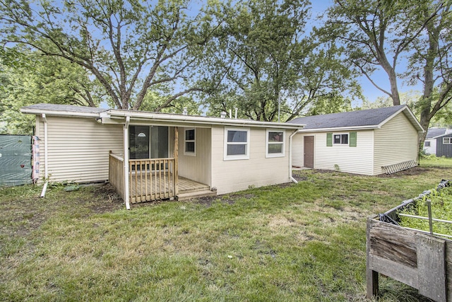3914 Clarnin St, Kalamazoo, MI 49004 - rear view of property with a lawn and a deck