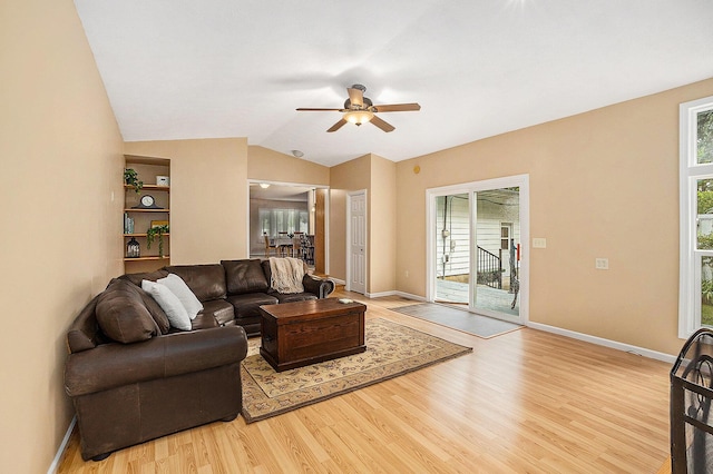 308 N Thomas St, Scottville, MI 49454 - living area featuring ceiling fan, light wood finished floors, and vaulted ceiling