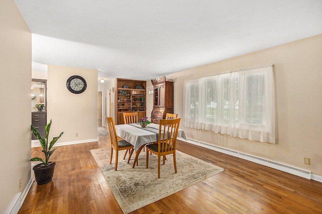 308 N Thomas St, Scottville, MI 49454 - dining room with a baseboard radiator and wood finished floors