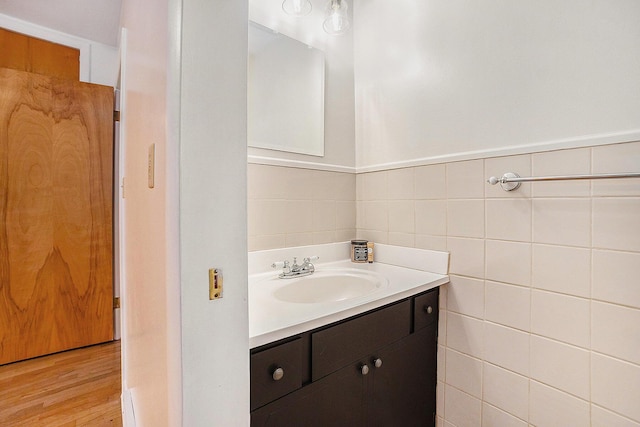 308 N Thomas St, Scottville, MI 49454 - bathroom featuring vanity, wood finished floors, and tile walls