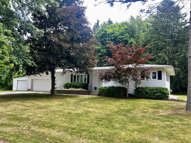 308 N Thomas St, Scottville, MI 49454 - view of front of property with a front lawn, driveway, and an attached garage