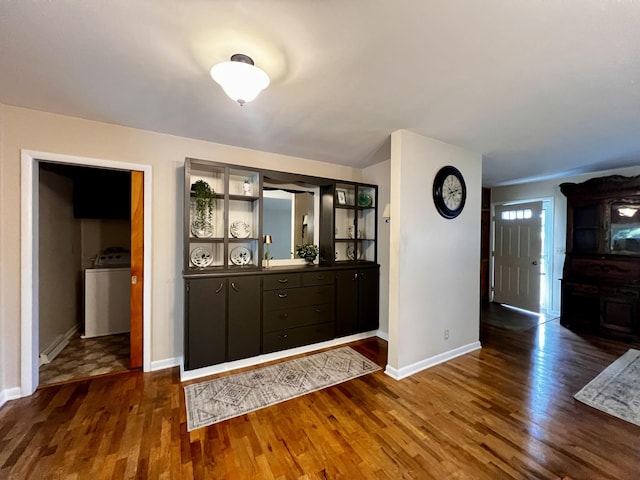 308 N Thomas St, Scottville, MI 49454 - entryway featuring washer / dryer and dark wood-style flooring