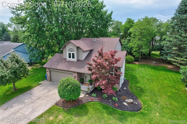 220 E Rolston Rd, Linden, MI 48451 - view of front of house with driveway, stone siding, and a front yard