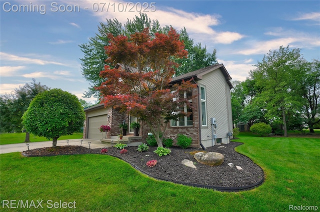220 E Rolston Rd, Linden, MI 48451 - view of front of home with a front yard, driveway, an attached garage, and brick siding