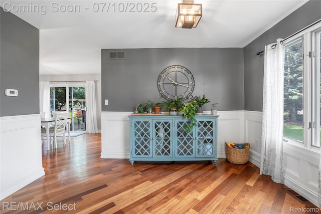 220 E Rolston Rd, Linden, MI 48451 - dining space with light wood-style floors, a decorative wall, and wainscoting