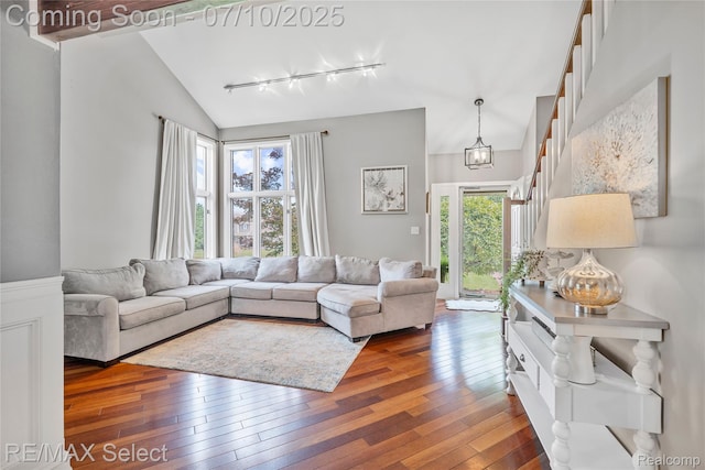 220 E Rolston Rd, Linden, MI 48451 - living room with rail lighting, wood-type flooring, and lofted ceiling