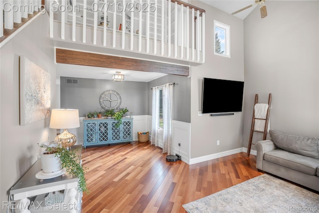 220 E Rolston Rd, Linden, MI 48451 - living room with wood finished floors, a ceiling fan, and a towering ceiling