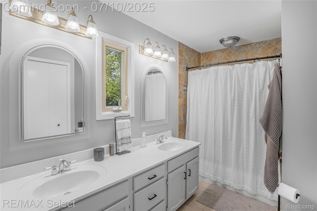 220 E Rolston Rd, Linden, MI 48451 - full bath featuring double vanity, tile walls, and tile patterned floors