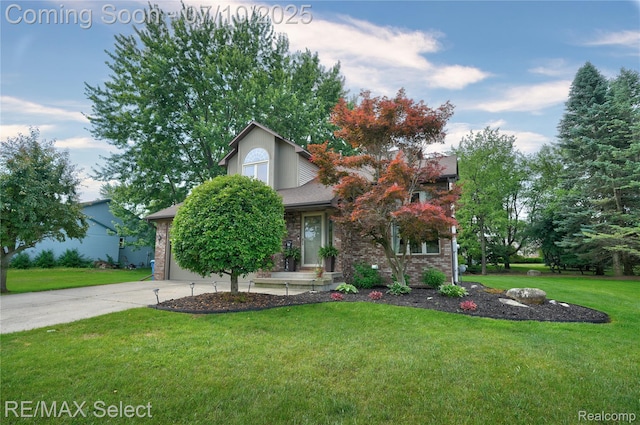 220 E Rolston Rd, Linden, MI 48451 - view of property hidden behind natural elements featuring a front lawn, brick siding, concrete driveway, and a garage