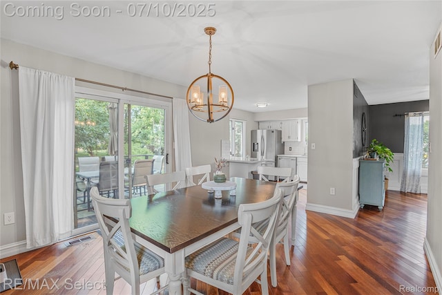 220 E Rolston Rd, Linden, MI 48451 - dining space featuring a chandelier, wood finished floors, and healthy amount of natural light