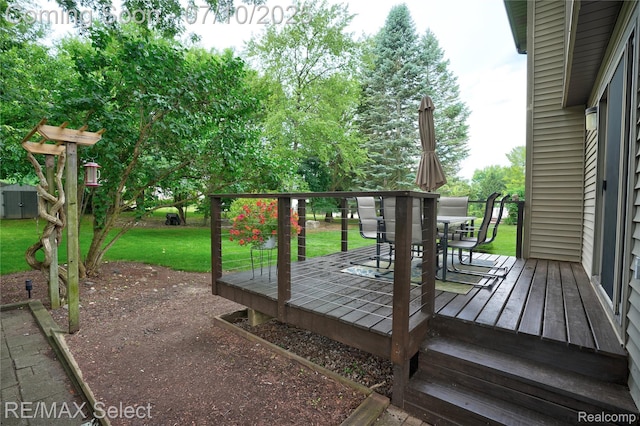 220 E Rolston Rd, Linden, MI 48451 - wooden terrace with outdoor dining space and a lawn