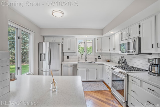 220 E Rolston Rd, Linden, MI 48451 - kitchen with appliances with stainless steel finishes, white cabinets, and decorative backsplash