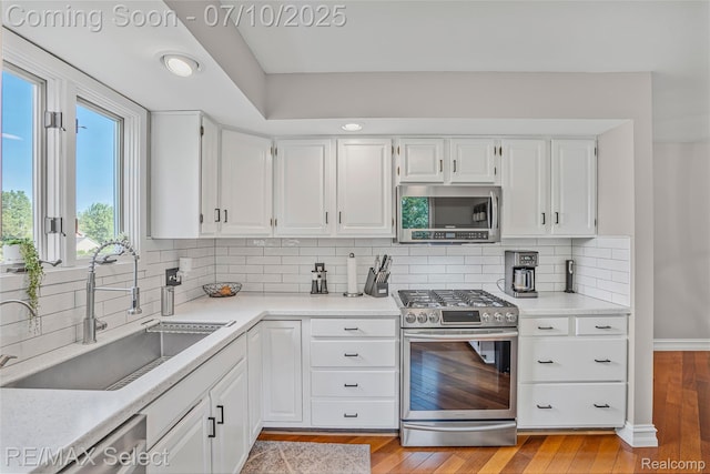 220 E Rolston Rd, Linden, MI 48451 - kitchen with stainless steel appliances, white cabinets, light countertops, and recessed lighting