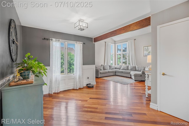 220 E Rolston Rd, Linden, MI 48451 - living area with hardwood / wood-style floors, wainscoting, and beam ceiling