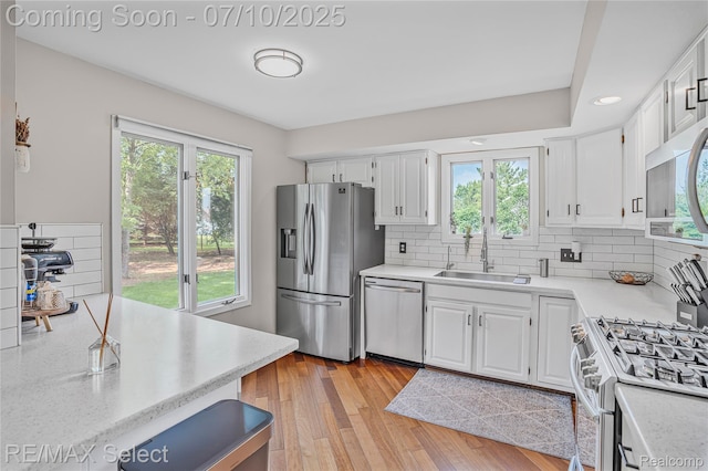 220 E Rolston Rd, Linden, MI 48451 - kitchen with appliances with stainless steel finishes, light countertops, and white cabinetry