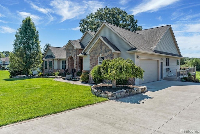 11068 Meadowview Dr, Goodrich, MI 48438 - view of front of house with concrete driveway, an attached garage, a front yard, stone siding, and a shingled roof