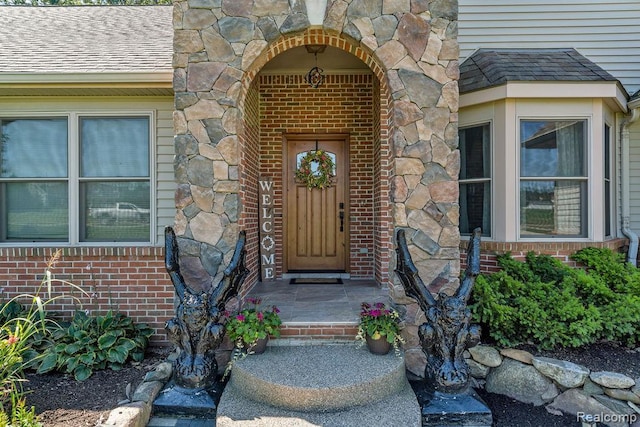 11068 Meadowview Dr, Goodrich, MI 48438 - entrance to property with stone siding, a shingled roof, and brick siding