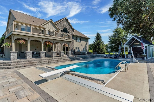 11068 Meadowview Dr, Goodrich, MI 48438 - outdoor pool with a patio area, a diving board, an outbuilding, and an outdoor living space