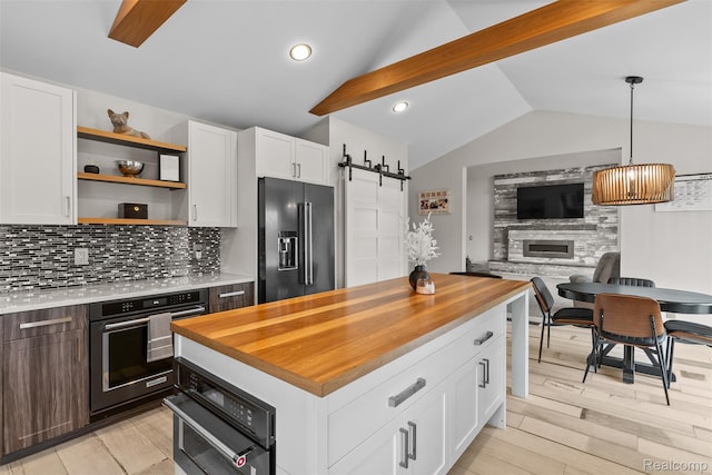 11068 Meadowview Dr, Goodrich, MI 48438 - kitchen with high end refrigerator, butcher block countertops, lofted ceiling, oven, and white cabinetry