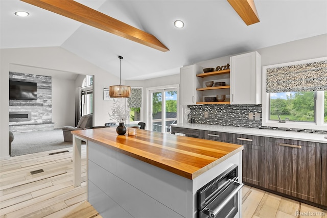 11068 Meadowview Dr, Goodrich, MI 48438 - kitchen with butcher block countertops, white cabinets, open shelves, open floor plan, and tasteful backsplash