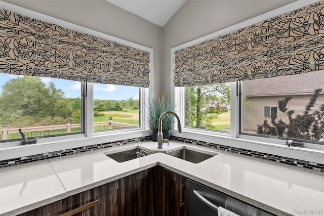 11068 Meadowview Dr, Goodrich, MI 48438 - kitchen featuring lofted ceiling, backsplash, dark brown cabinetry, and light stone countertops