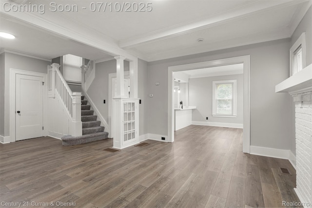 4115 Montgomery St, Detroit, MI 48204 - unfurnished living room with wood finished floors, stairway, and crown molding