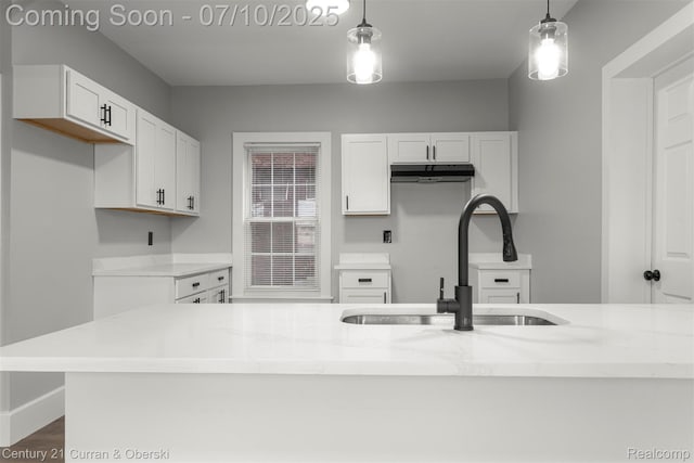 4115 Montgomery St, Detroit, MI 48204 - kitchen with hanging light fixtures, white cabinets, and light stone countertops