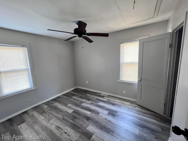 7511 Orchard Ave, Warren, MI 48091 - unfurnished room featuring attic access, dark wood-type flooring, and ceiling fan