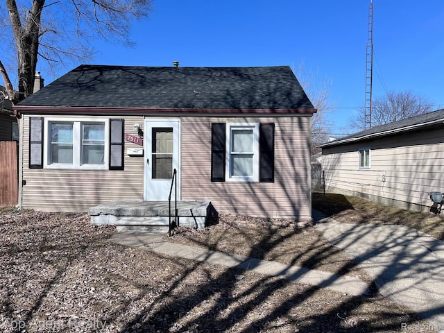 7511 Orchard Ave, Warren, MI 48091 - rear view of property featuring a shingled roof and a chimney