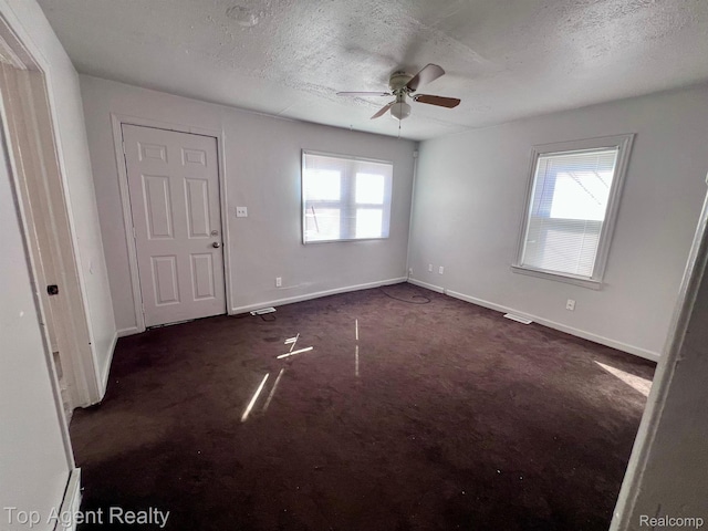7511 Orchard Ave, Warren, MI 48091 - entryway with plenty of natural light, a textured ceiling, ceiling fan, and dark carpet