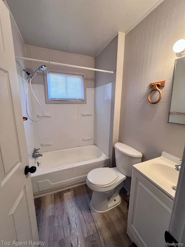 7511 Orchard Ave, Warren, MI 48091 - bathroom featuring wood finished floors, tile walls, shower / tub combination, and vanity
