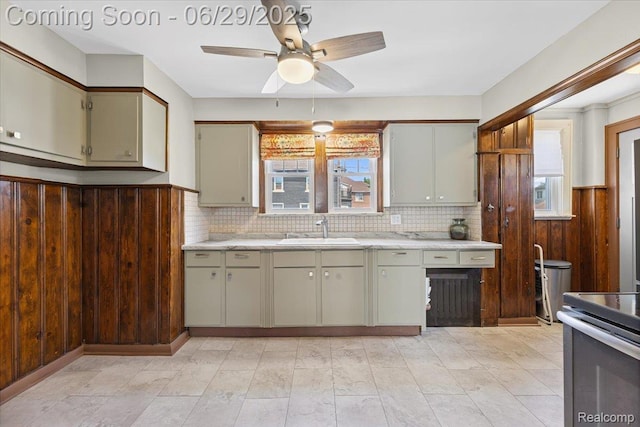 103 Elm St, River Rouge, MI 48218 - kitchen with plenty of natural light, stainless steel range with electric cooktop, ceiling fan, decorative backsplash, and wooden walls