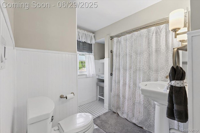 103 Elm St, River Rouge, MI 48218 - bathroom with a wainscoted wall, curtained shower, and tile patterned floors