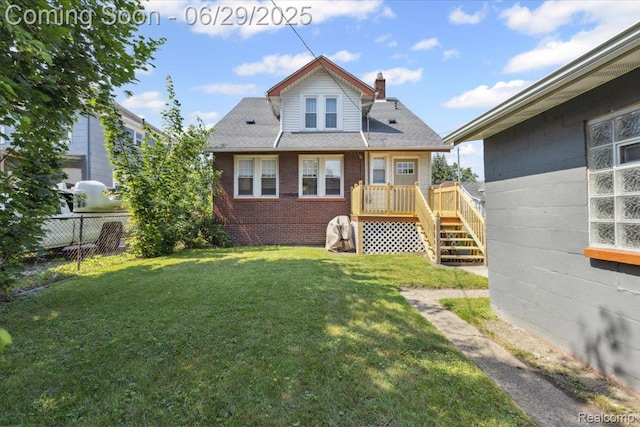 103 Elm St, River Rouge, MI 48218 - back of property featuring a chimney, brick siding, a wooden deck, and stairs