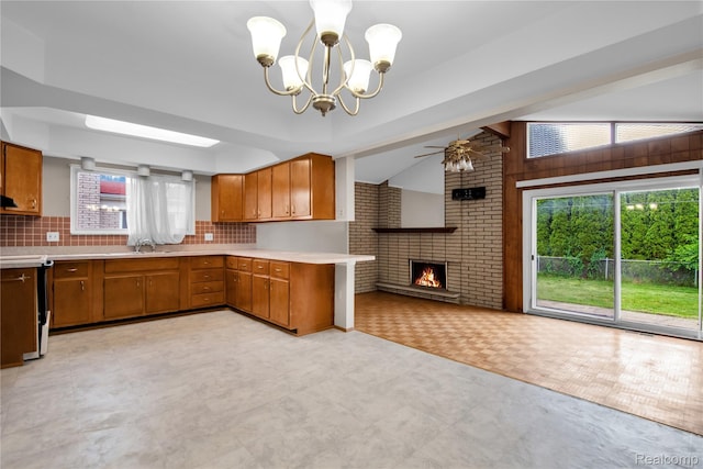 30232 Austin Dr, Warren, MI 48092 - kitchen featuring brown cabinets, light countertops, a chandelier, open floor plan, and vaulted ceiling