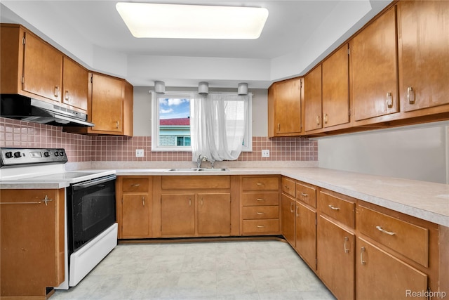 30232 Austin Dr, Warren, MI 48092 - kitchen with range with electric stovetop, under cabinet range hood, light countertops, and brown cabinetry