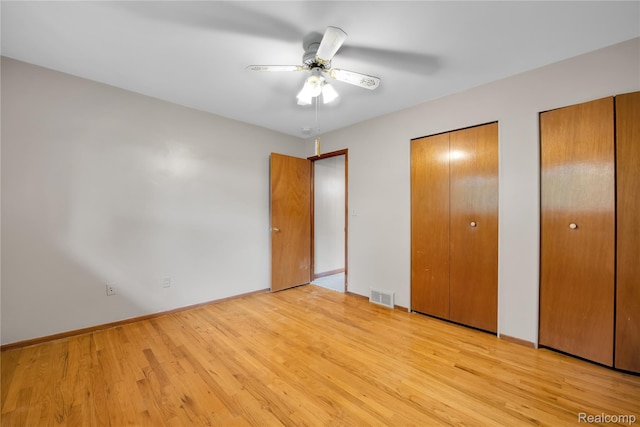 30232 Austin Dr, Warren, MI 48092 - unfurnished bedroom with two closets, light wood-style floors, and ceiling fan