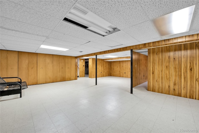 30232 Austin Dr, Warren, MI 48092 - finished basement with tile patterned floors, wood walls, and a paneled ceiling