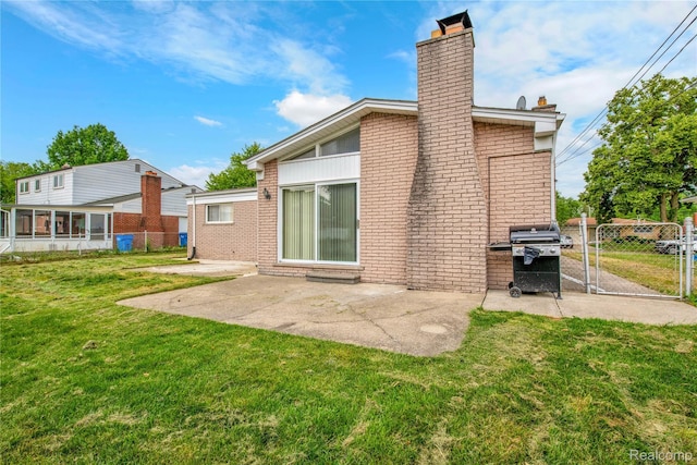 30232 Austin Dr, Warren, MI 48092 - rear view of house with a chimney, brick siding, a patio area, and a gate
