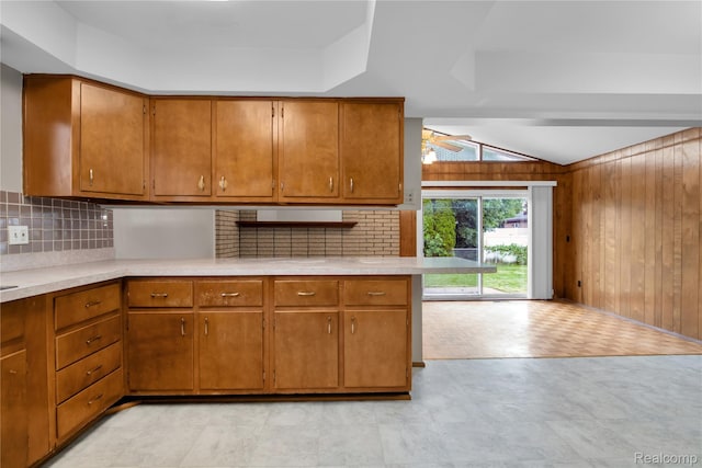 30232 Austin Dr, Warren, MI 48092 - kitchen featuring wood walls, light countertops, brown cabinets, backsplash, and light floors